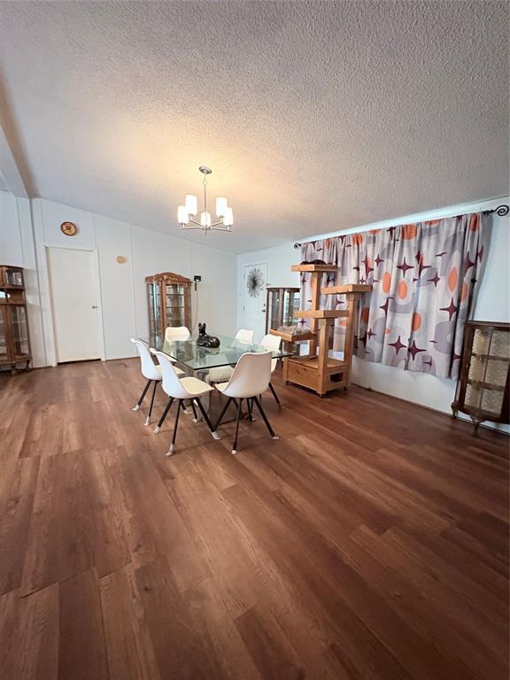 6295 Rendon New Hope Road Fort Worth, TX 76140 - Photo 20 of 38 Dining area with dark wood finished floors, suspended lighting, and a textured ceiling