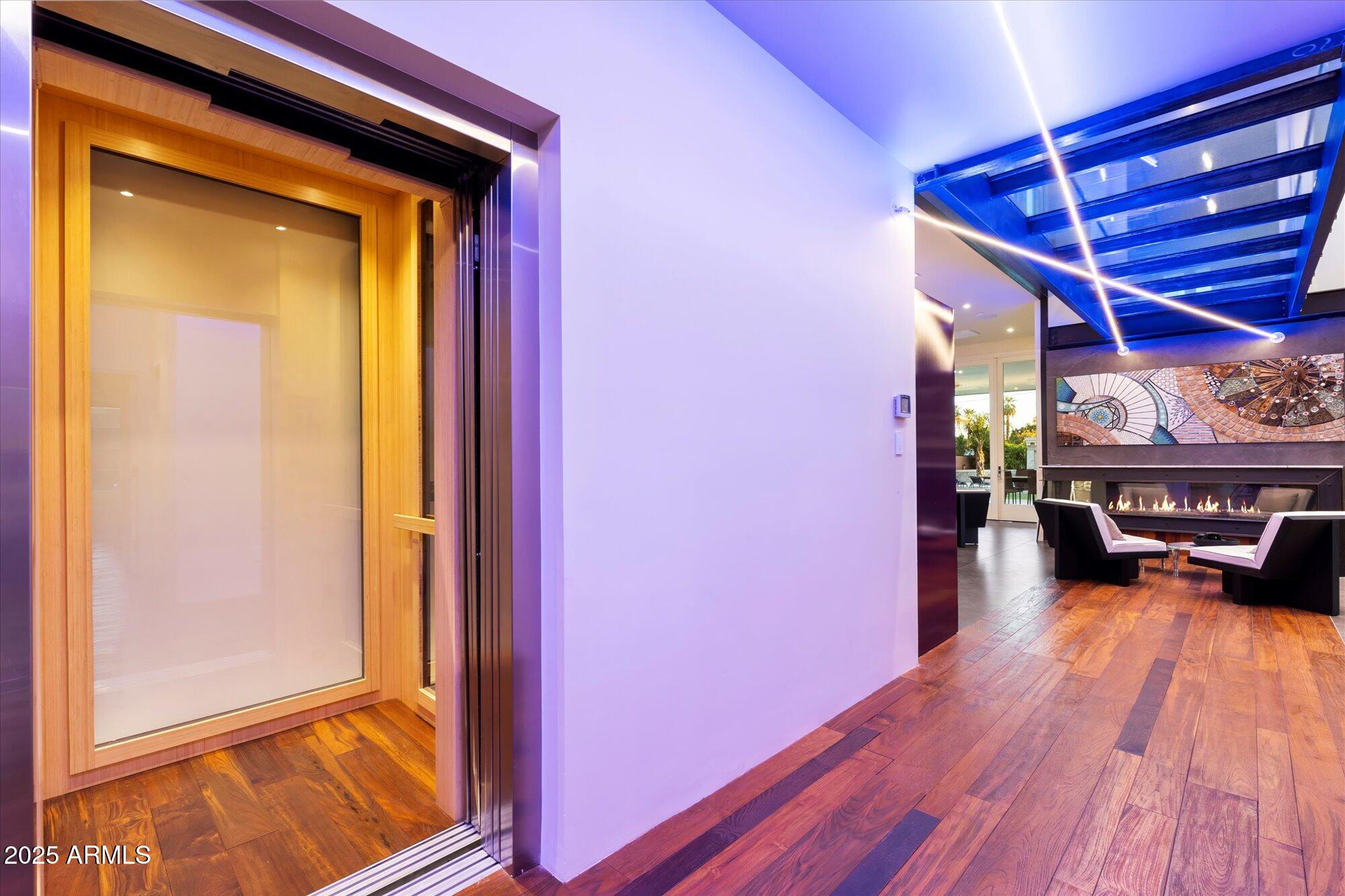 341 East Monte Vista Road Phoenix, AZ 85004 - Photo 15 of 77 a view of a living room with a bed and wooden floor