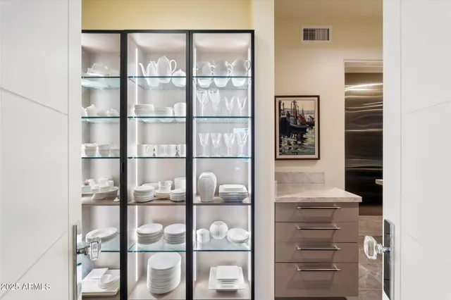 a large kitchen with stainless steel appliances wooden cabinets and a counter top