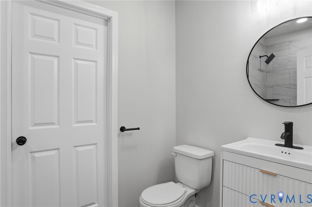 3490 Willow Brook Road Bumpass, VA 23024 - Photo 24 of 29 a bathroom with a toilet sink and mirror