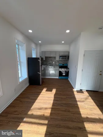 a kitchen with stainless steel appliances kitchen island sink refrigerator and stove