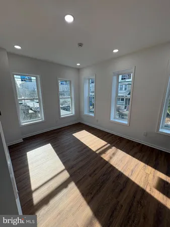 a view of wooden floor and windows in a room