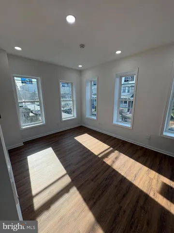 a view of wooden floor and windows in a room