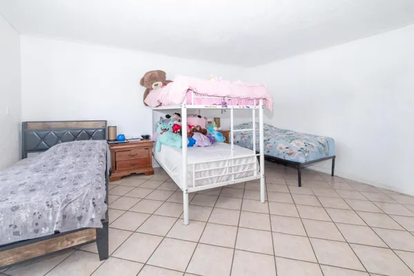 a kitchen with white cabinets appliances and a sink