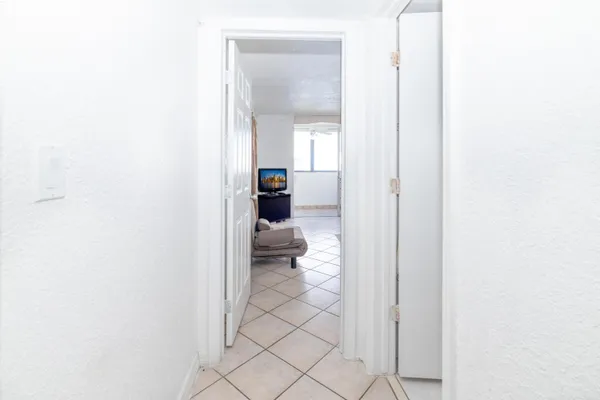 a kitchen with granite countertop white cabinets and appliances