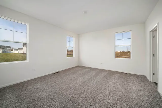 a view of an empty room and a window