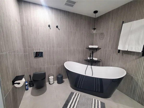 a bathroom with a sink a toilet and bathtub