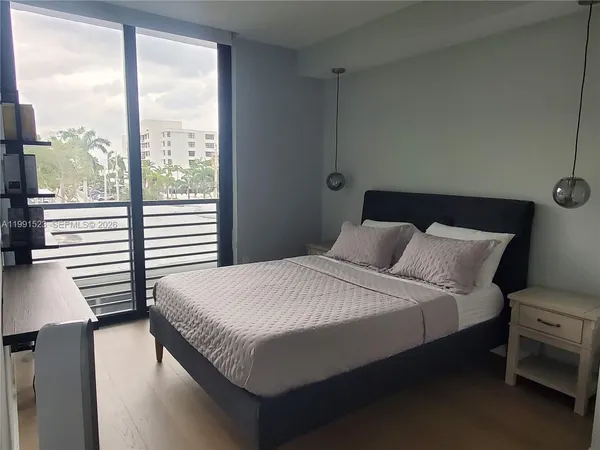 a bed sitting in a bedroom next to a window