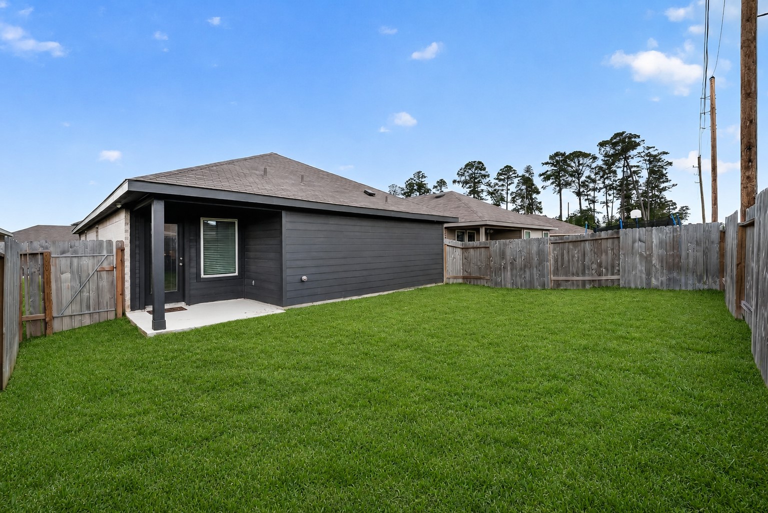 24318 Pebble Crescent Ln Spring Spring, TX 77373 - Photo 28 of 30 Step outside to a fully fenced backyard designed for both relaxation and entertaining! Enjoy morning coffee or evening gatherings under the covered patio while taking in the spacious yard with plenty of room for pets, play, gardening, or future outdoor additions. This private outdoor retreat offers the perfect blend of comfort, functionality, and space to enjoy year-round.