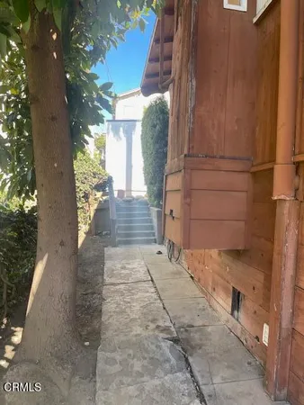 a view of a pathway both side of house