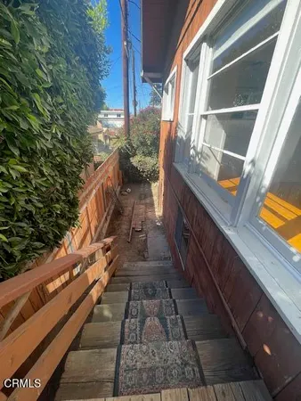 a view of a balcony with wooden floor and stairs