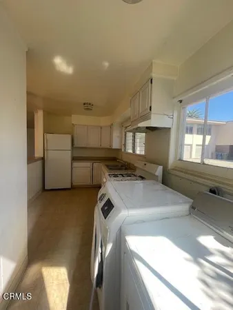 a kitchen with storage and utility