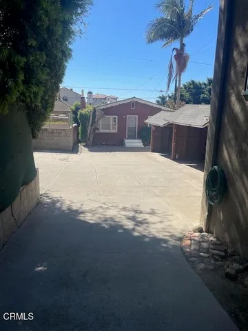 a view of a yard with a house in the background