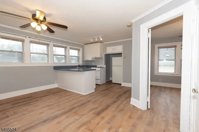 a view of a kitchen with wooden floor and a kitchen