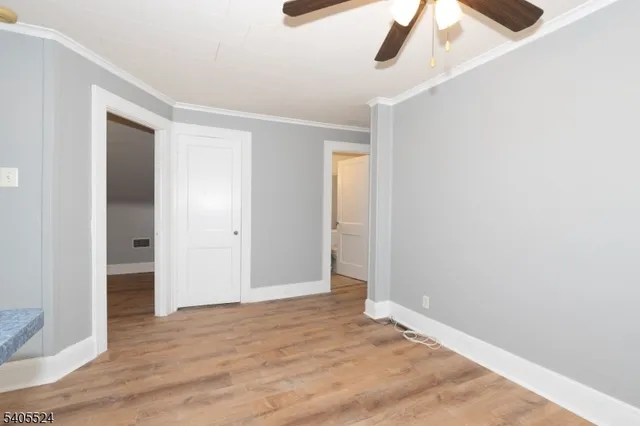 an empty room with wooden floor and closet