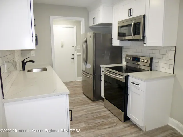 a kitchen with a refrigerator sink and microwave