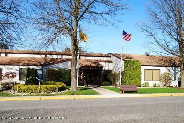 a view of street along with house and car parked