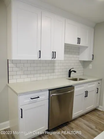 a kitchen with stainless steel appliances granite countertop a sink and cabinets