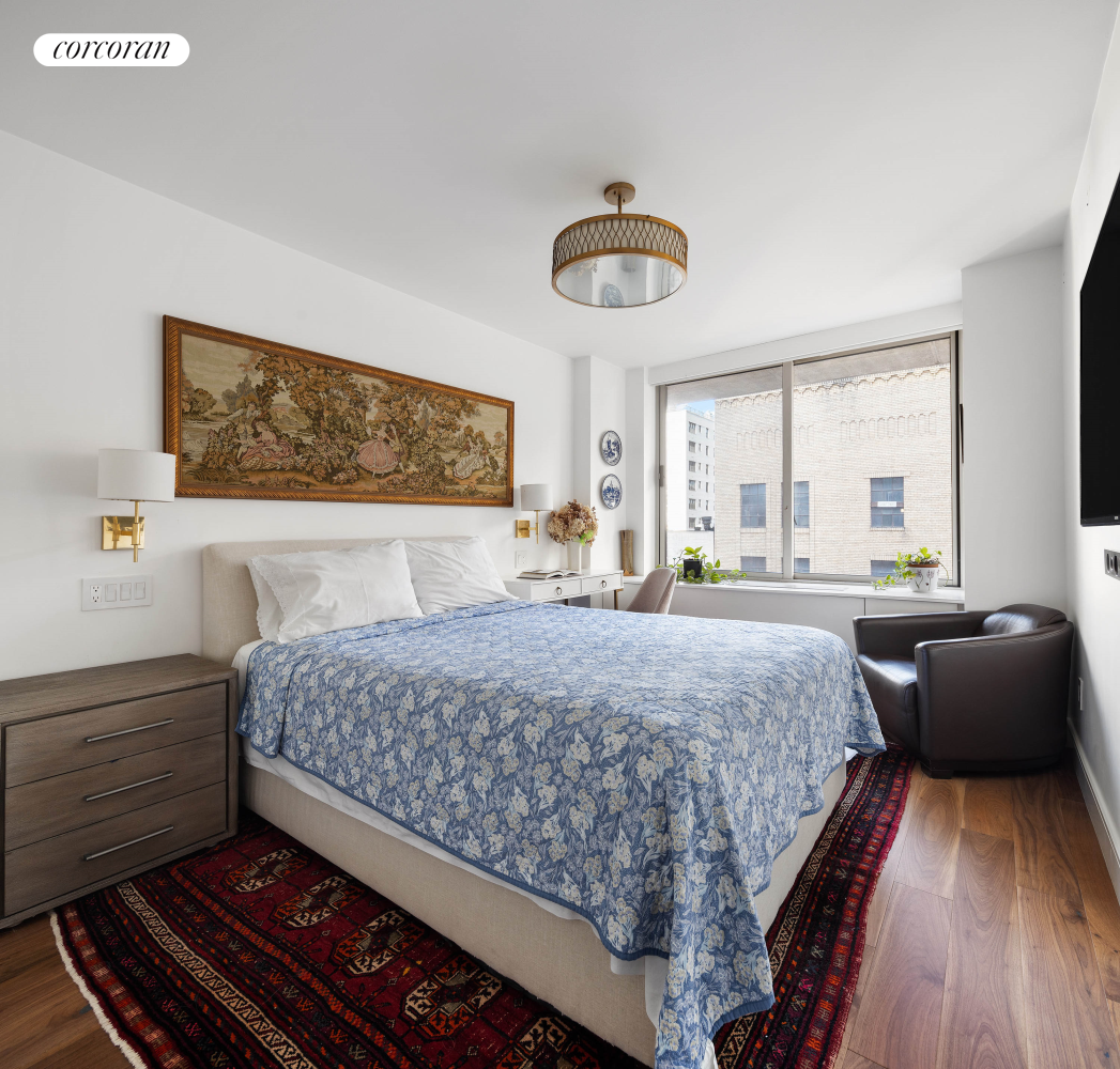 170 East 87th Street, Unit W7C Manhattan, NY 10128 - Photo 12 of 15 a bedroom with a bed and a couch