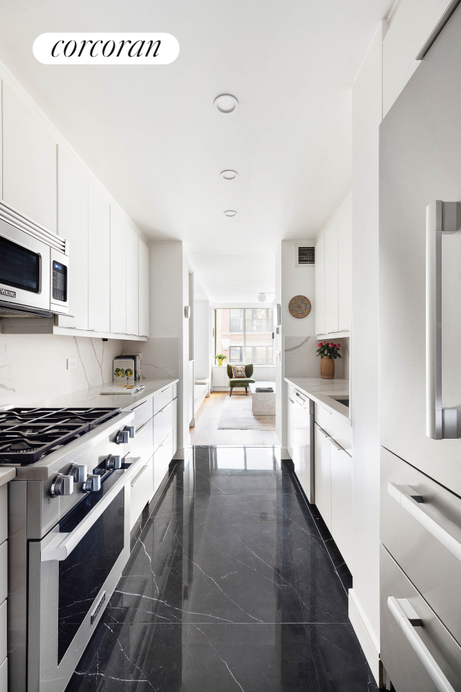 170 East 87th Street, Unit W7C Manhattan, NY 10128 - Photo 4 of 15 a large white kitchen with stainless steel appliances