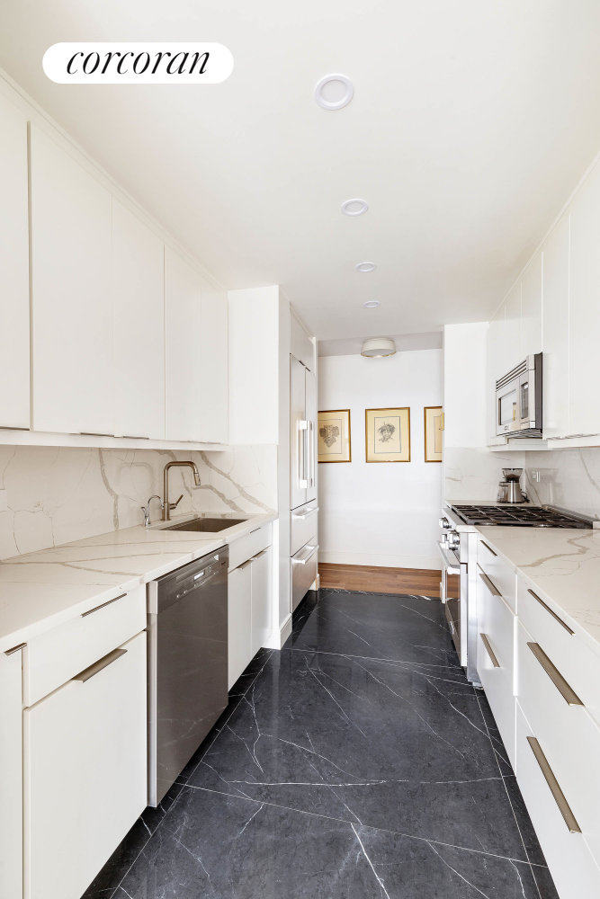 170 East 87th Street, Unit W7C Manhattan, NY 10128 - Photo 5 of 15 a kitchen with a stove top oven sink and cabinets