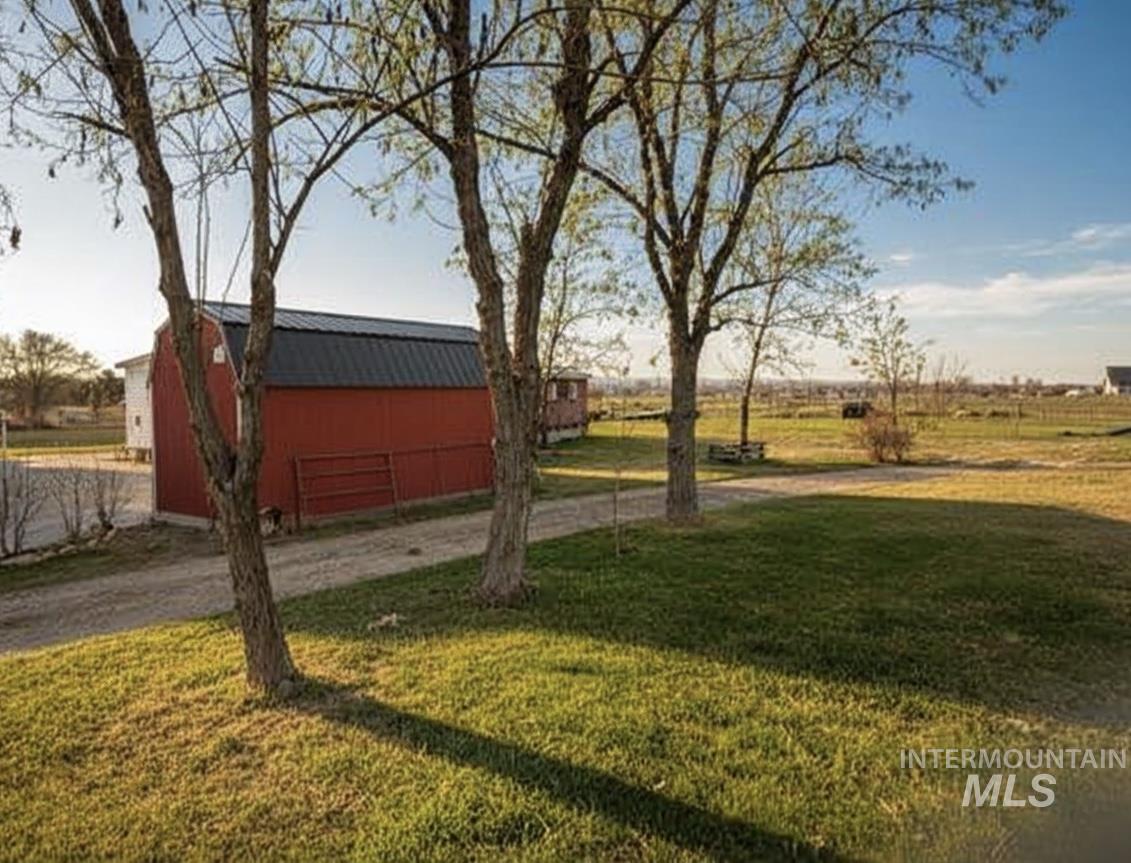 3065 Center Avenue Payette, ID 83661 - Photo 1 of 3 View of grassy yard featuring an outdoor structure and a view of rural / pastoral area