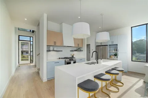 a living room with furniture appliances and a large window