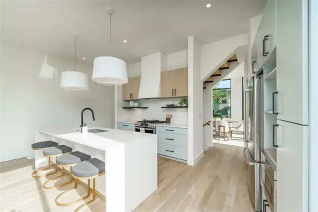 a view of living room with granite countertop furniture a sink a window and stainless steel appliances