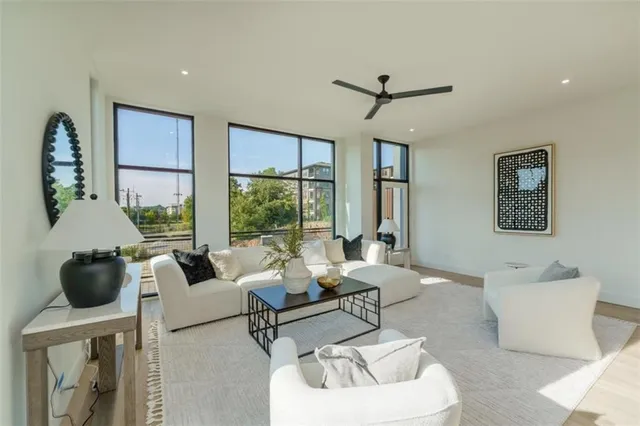 a living room with fireplace furniture and a large window