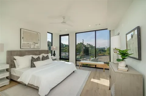 a living room with furniture city view and a large window