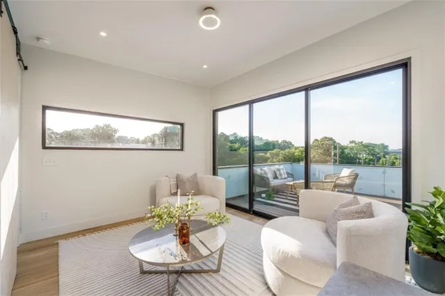 a living room with furniture city view and a large window