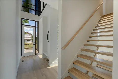 a kitchen with stainless steel appliances a table and chairs in it