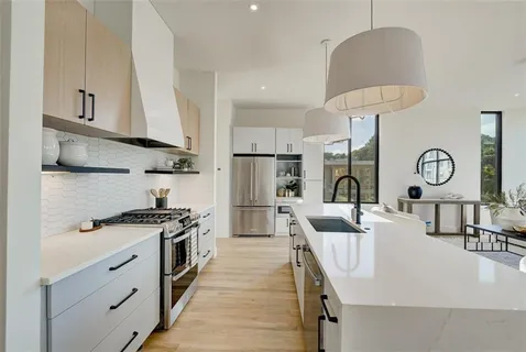 a view of living room with granite countertop furniture a sink a window and stainless steel appliances
