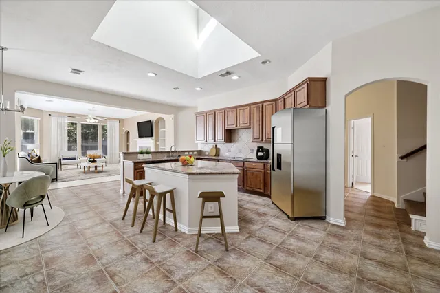 a large white kitchen with a sink and cabinets
