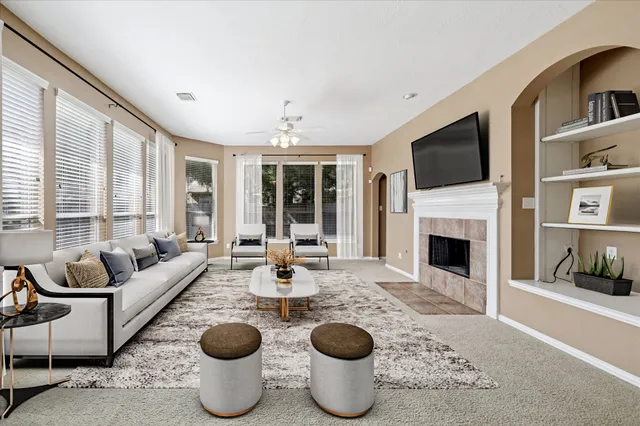 a view of an empty room with a fireplace and a window
