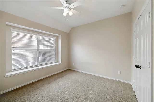 a bedroom with a bed mirror and a window