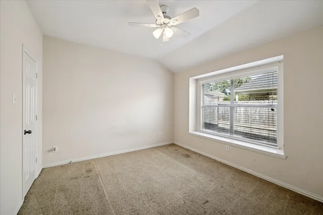 a bedroom with a bed a mirror and a window