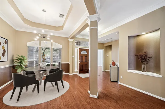a view of a dining room with furniture window and wooden floor
