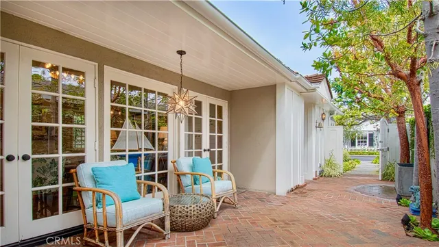 a view of a door with a chairs and table in a patio