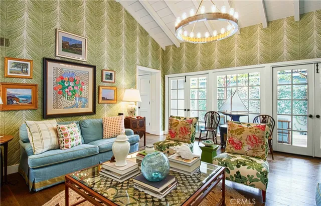 a living room with furniture and a floor to ceiling window