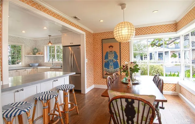 a very nice looking dining room with wooden floor and windows