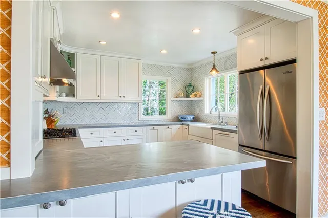 a kitchen with a refrigerator a sink and cabinets
