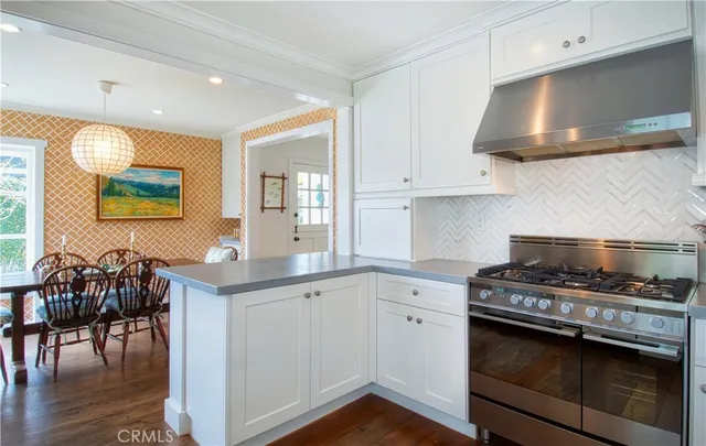 a kitchen with granite countertop a stove a sink and a refrigerator