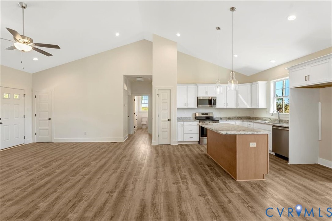 4752 Country Club Road La Crosse, VA 23950 - Photo 13 of 35 a kitchen with a refrigerator a sink and dishwasher a oven with wooden floor