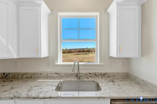 a large kitchen with cabinets and wooden floor