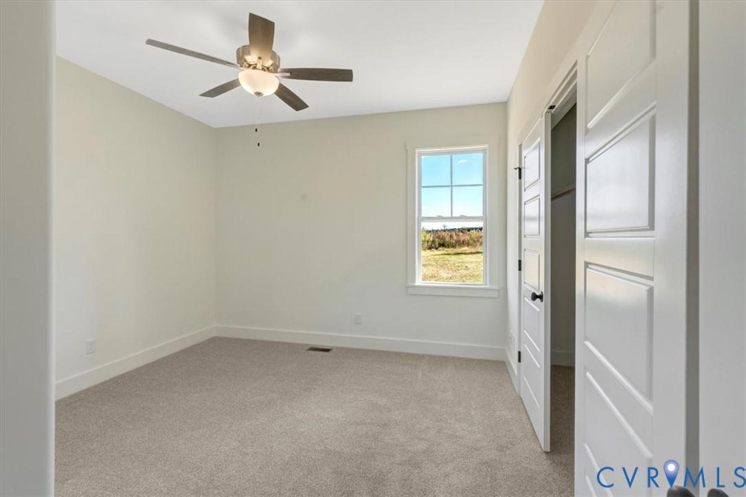 4752 Country Club Road La Crosse, VA 23950 - Photo 31 of 35 an empty room with a window and a ceiling fan