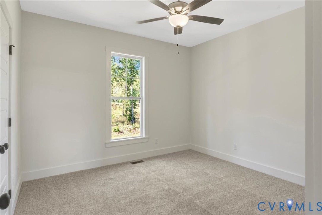4752 Country Club Road La Crosse, VA 23950 - Photo 35 of 35 an empty room with a window and a fan