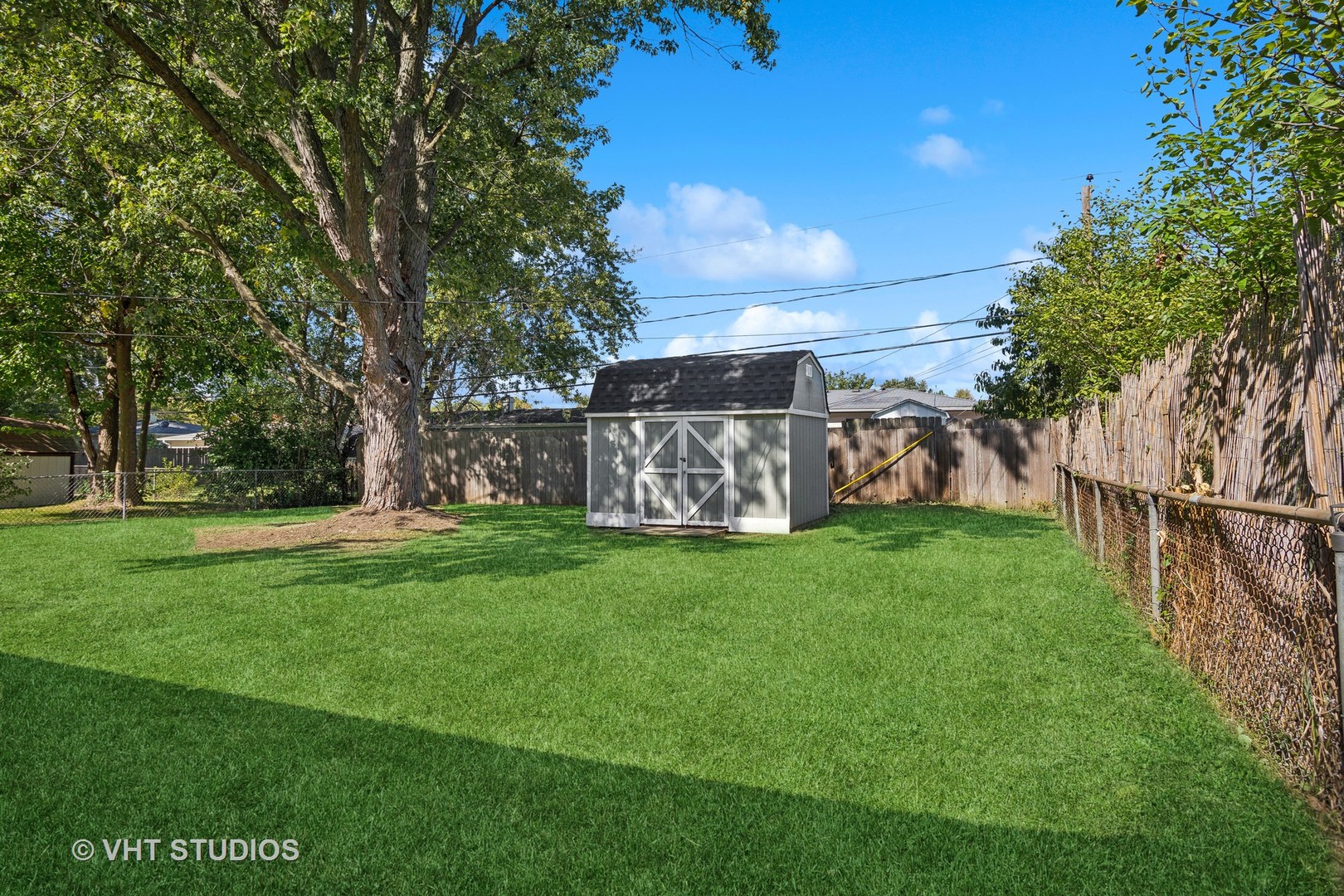 412 Cahill Road Streamwood, IL 60107 - Photo 16 of 16 a view of a yard with a large tree