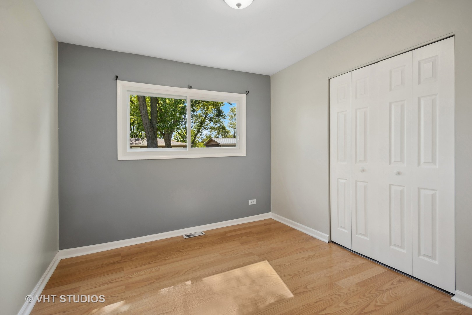 412 Cahill Road Streamwood, IL 60107 - Photo 10 of 16 a view of an empty room with a window