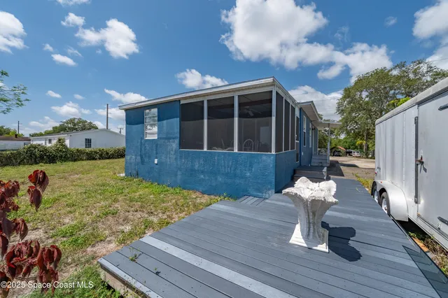 a view of a house with backyard sitting area and garden
